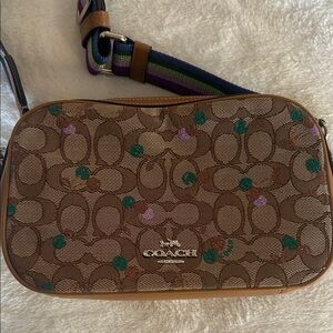 Like new Coach monogram crossbody with glittery cherry print and rainbow strap